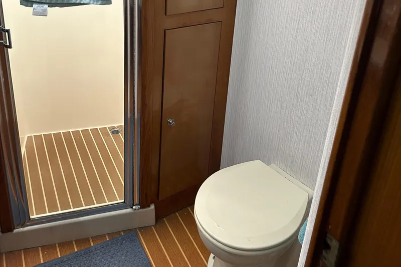 Slide: The Image of 2005 Post 53 Convertible bathroom with shower and wooden flooring. - 13