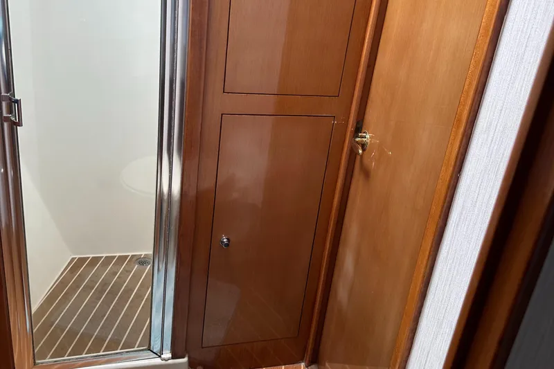 Slide: The Image of 2005 Post 53 Convertible yacht bathroom with wooden cabinetry and shower. - 14
