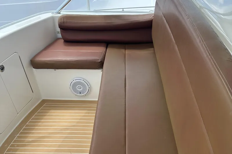 Slide: The Image of 2005 Post 53 Convertible boat interior with brown leather seating and wood flooring. - 20