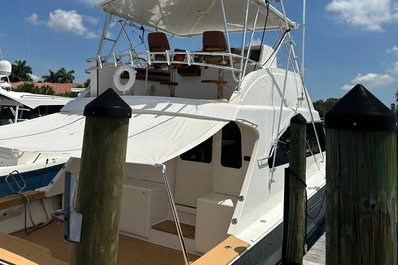 Slide: The Image of 2005 Post 53 Convertible yacht docked at marina under clear blue sky. - 27