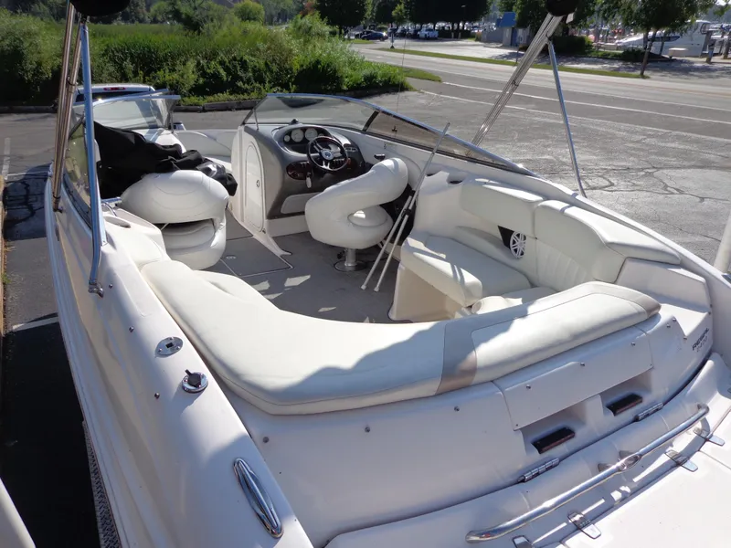 Slide: The Image of 2007 Regal 2400 Bowrider with spacious white seating and modern dashboard. - 5