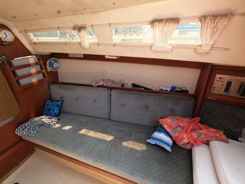 Slide: The Image of Interior of a 1985 Catalina 27 sailboat with cushions and nautical decor. - 10