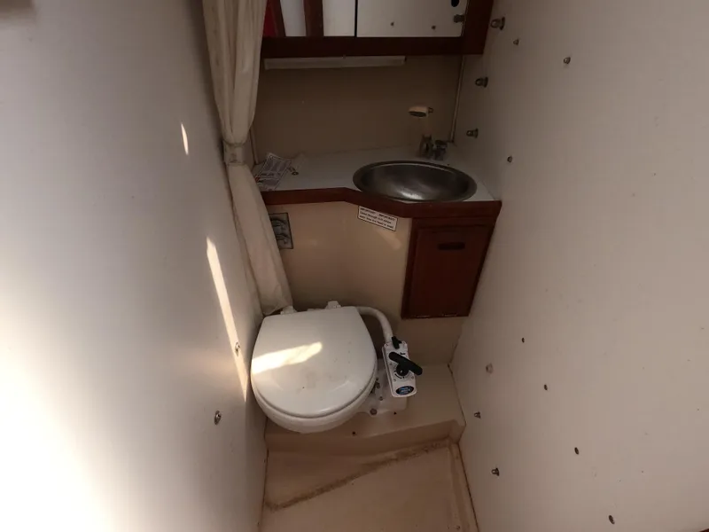 Slide: The Image of Compact bathroom in a 1985 Catalina 27 sailboat with toilet and sink. - 14