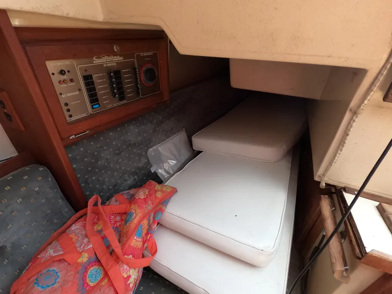 Slide: The Image of Interior of a 1985 Catalina 27 sailboat with cushions and control panel. - 9