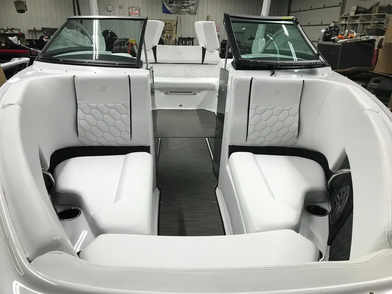 Slide: The Image of 2025 Four Winns H4 boat interior with white seating and modern design. - 11