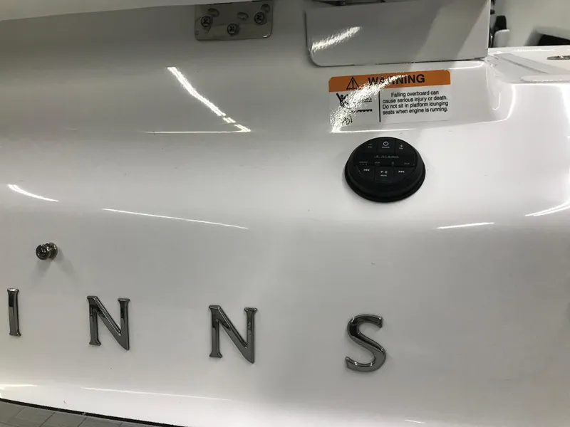 Slide: The Image of 2025 Four Winns H4 boat exterior with warning label and partial logo. - 15