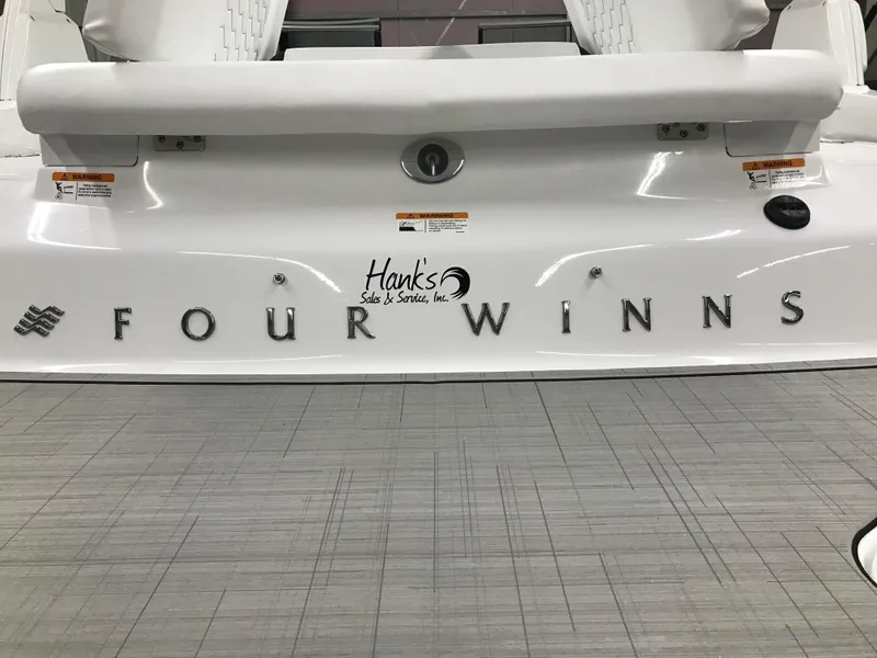 Slide: The Image of 2025 Four Winns H4 boat rear view with logo and branding. - 16