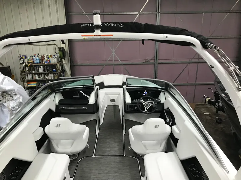 Slide: The Image of 2025 Four Winns H4 boat interior with white seating and sleek design. - 20