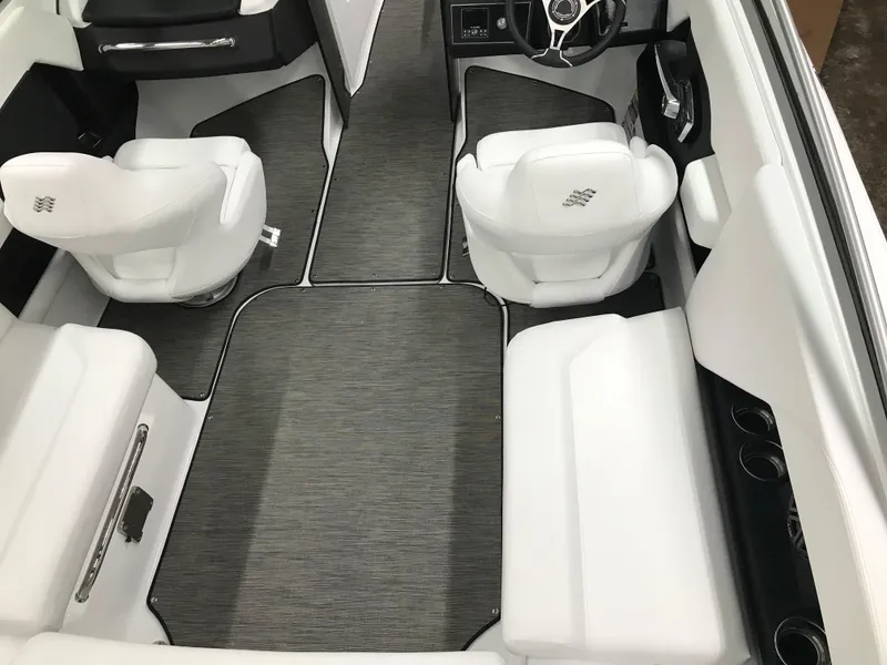 Slide: The Image of 2025 Four Winns H4 boat interior with white seating and gray flooring. - 22