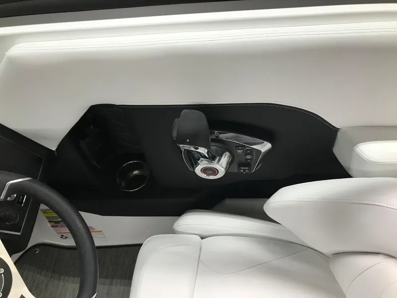 Slide: The Image of Interior of 2025 Four Winns H4 boat, featuring sleek white seating and modern controls. - 24