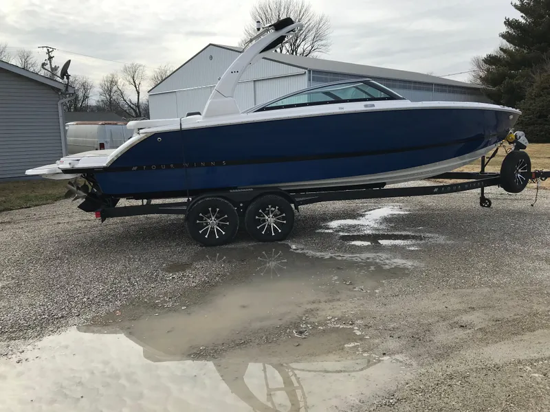 Slide: The Image of 2025 Four Winns H4 boat on trailer, parked outdoors near buildings. - 3