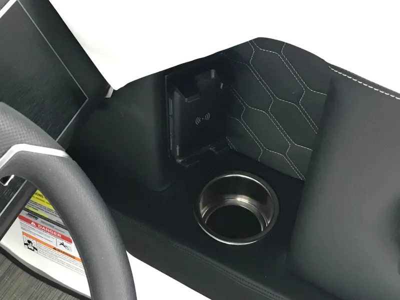 Slide: The Image of 2025 Four Winns H4 interior with cup holder and wireless charging pad. - 30