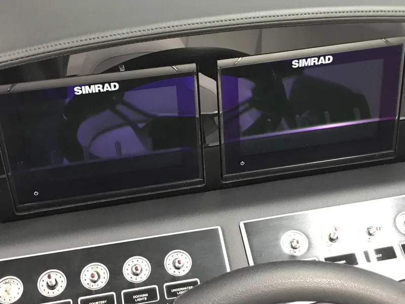 Slide: The Image of Dashboard of 2025 Four Winns H4 boat with dual Simrad displays. - 36