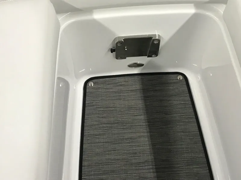 Slide: The Image of 2025 Four Winns H4 boat interior storage compartment with gray mat. - 38