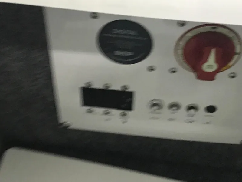 Slide: The Image of Control panel of 2025 Four Winns H4 boat with digital display and red dial. - 42