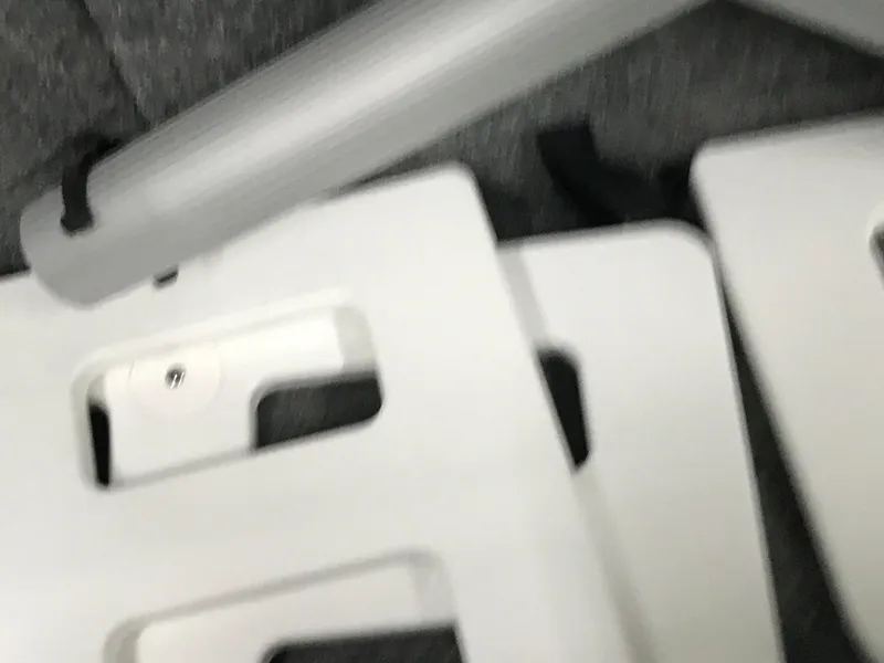 Slide: The Image of Close-up of 2025 Four Winns H4 boat interior components, featuring white panels and metallic elements. - 43