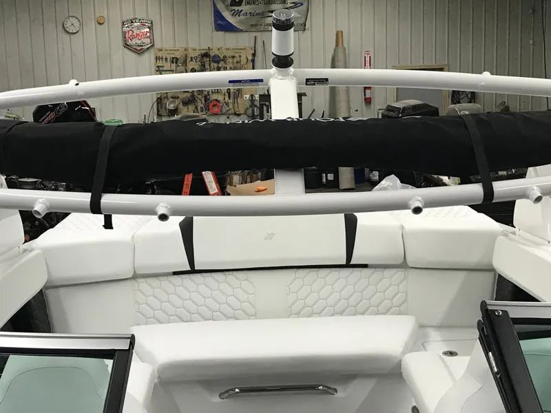 Slide: The Image of 2025 Four Winns H4 boat interior with white seating and black accents. - 44