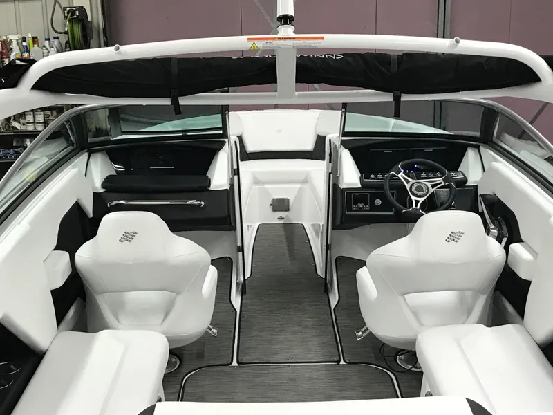 Slide: The Image of 2025 Four Winns H4 boat interior with modern white seating and sleek dashboard design. - 45
