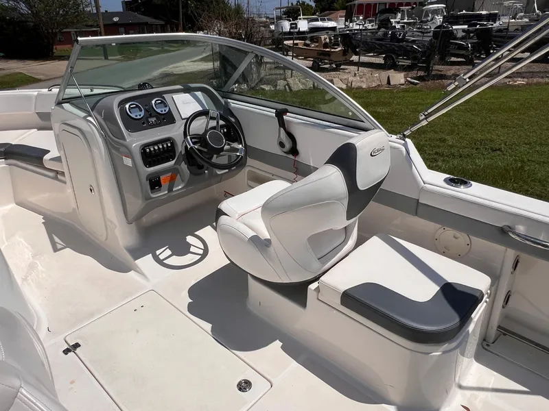 Slide: The Image of 2021 Robalo R227 Dual Console boat interior with steering wheel and seating. - 10