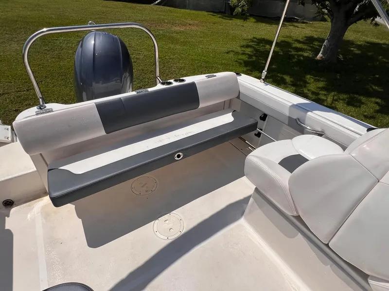 Slide: The Image of 2021 Robalo R227 Dual Console boat interior with seating and motor. - 13