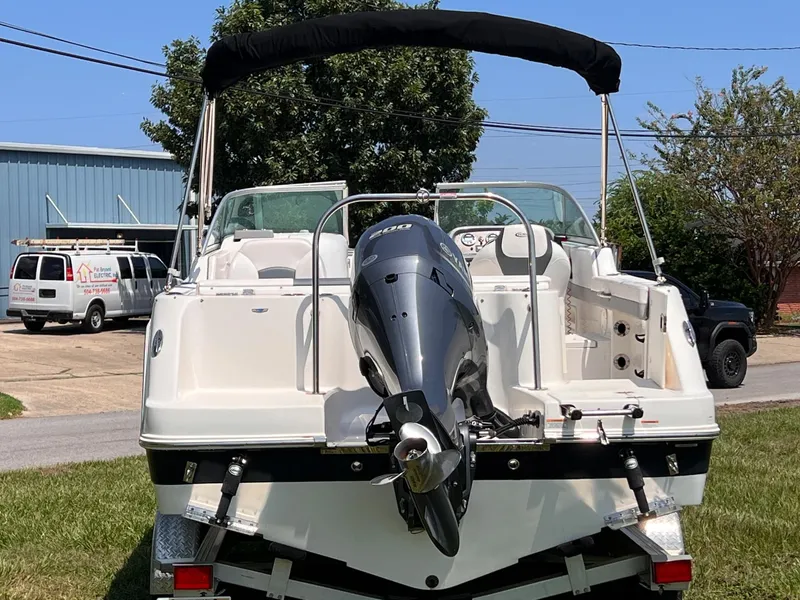 Slide: The Image of 2021 Robalo R227 Dual Console boat with outboard motor, parked on grass. - 7