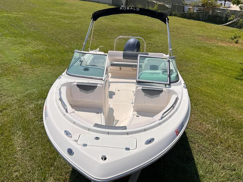 Slide: The Image of 2021 Robalo R227 Dual Console boat on grass, front view. - 8