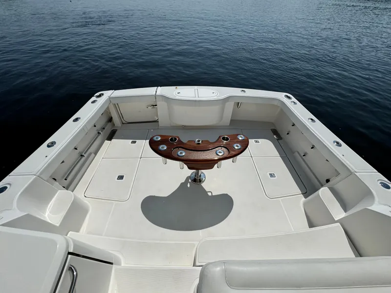 Slide: The Image of Tiara Yachts 2019 4300 Open boat deck with fishing rod holders, on calm water. - 10