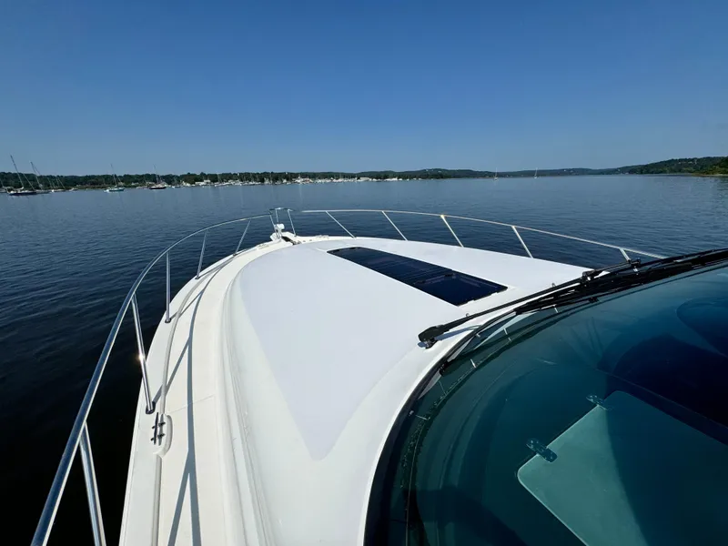 Slide: The Image of Tiara Yachts 4300 Open 2019 cruising on calm waters under clear blue sky. - 12