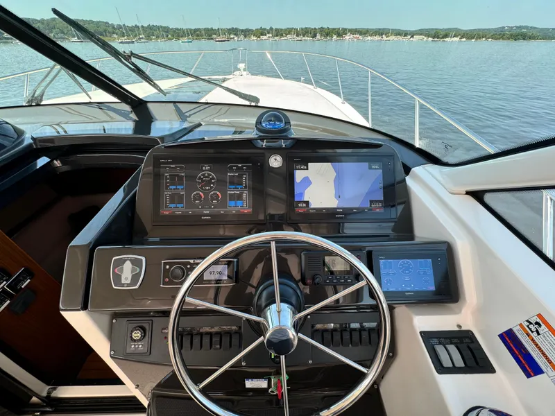 Slide: The Image of Tiara Yachts 4300 Open 2019 helm with navigation screens on calm water. - 17