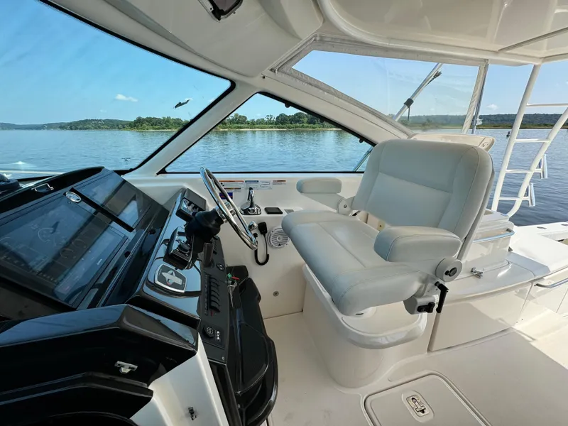 Slide: The Image of Interior view of 2019 Tiara Yachts 4300 Open helm with luxurious seating and controls. - 20