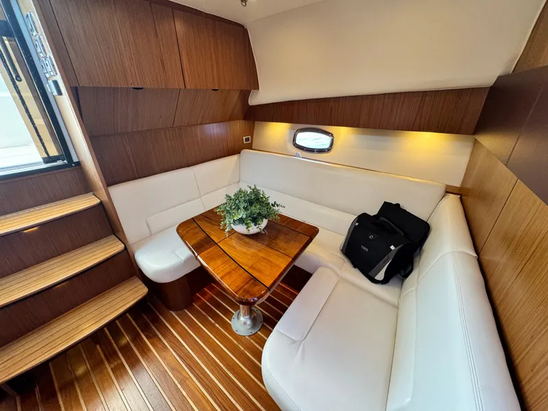 Slide: The Image of Luxurious interior of 2019 Tiara Yachts 4300 Open with elegant seating and wooden accents. - 23