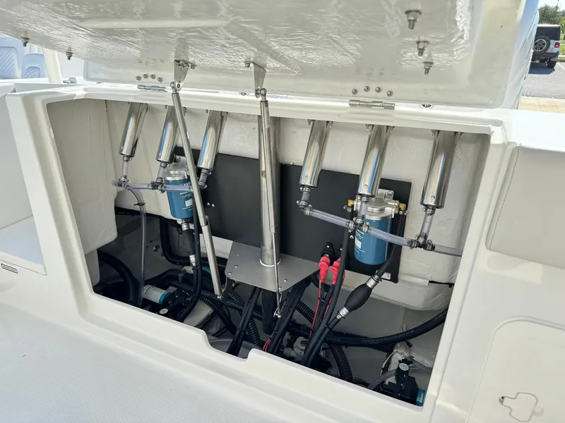 Slide: The Image of 2025 Sailfish 272 CC boat engine compartment with hydraulic systems and wiring. - 11