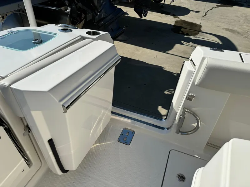 Slide: The Image of 2025 Sailfish 272 CC boat interior with open door and storage compartment. - 12