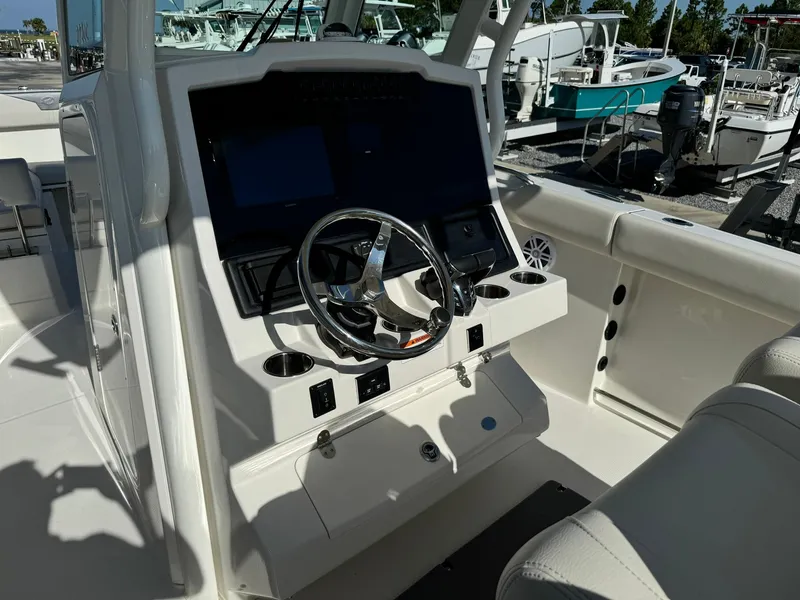 Slide: The Image of 2025 Sailfish 272 CC boat cockpit with steering wheel and control panel. - 17