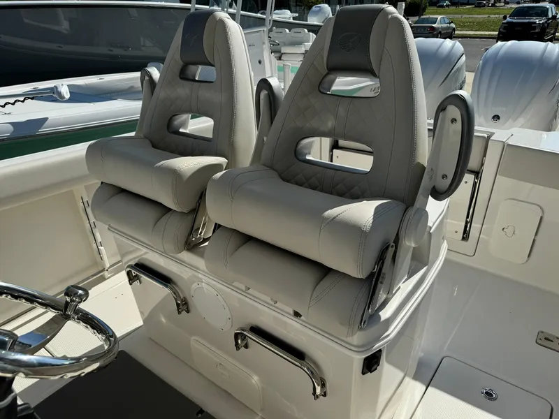 Slide: The Image of 2025 Sailfish 272 CC boat with dual cushioned seats and steering wheel. - 20