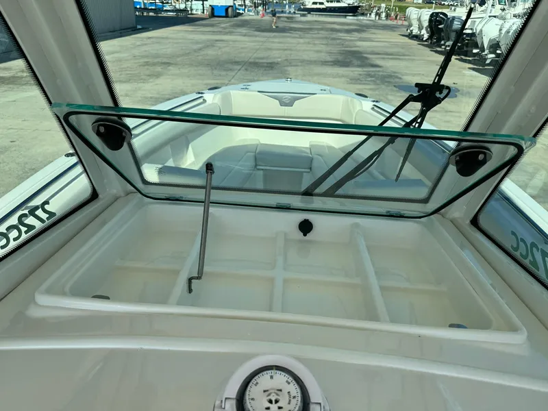 Slide: The Image of 2025 Sailfish 272 CC boat interior with open windshield and storage compartment. - 21