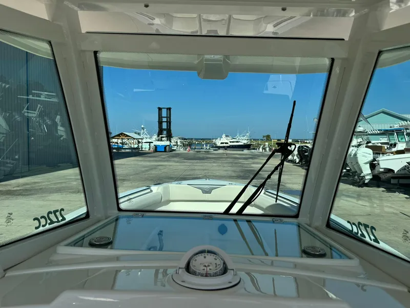 Slide: The Image of View from 2025 Sailfish 272 CC boat cockpit overlooking marina and docked boats. - 24
