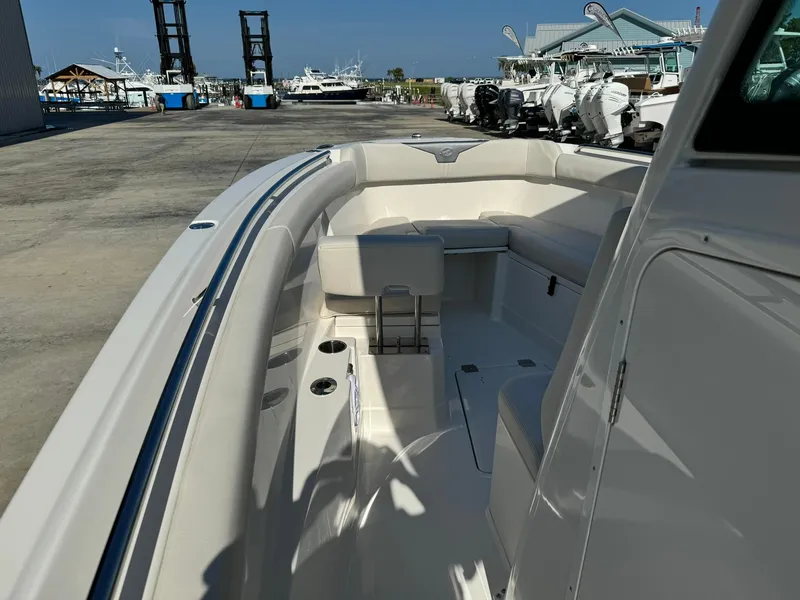 Slide: The Image of 2025 Sailfish 272 CC boat interior at marina, showcasing seating and deck layout. - 31