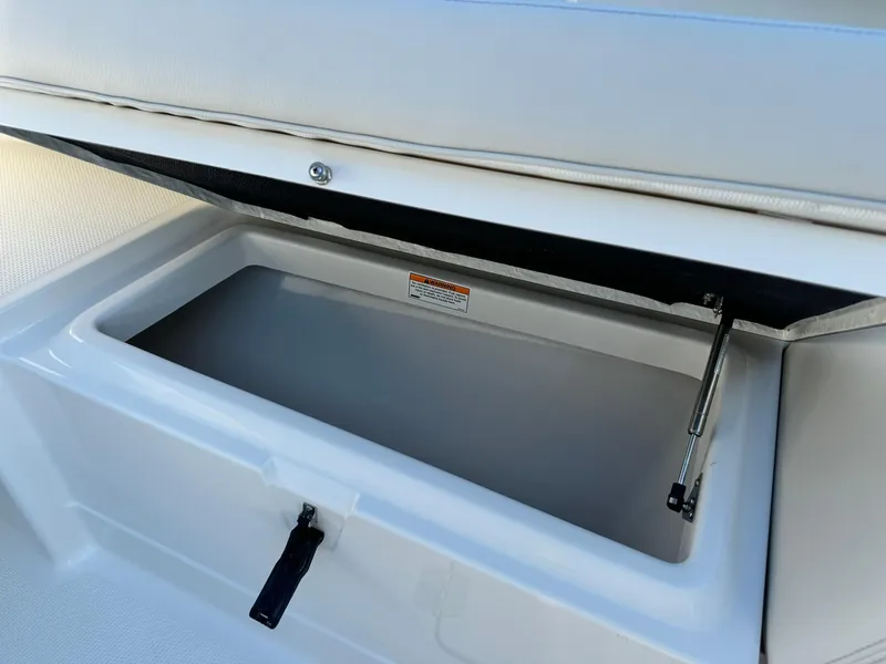Slide: The Image of 2025 Sailfish 272 CC boat storage compartment with open lid. - 35