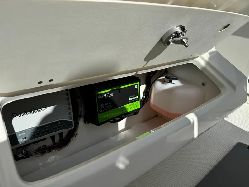 Slide: The Image of 2025 Sailfish 272 CC storage compartment with electronic equipment and wiring. - 40