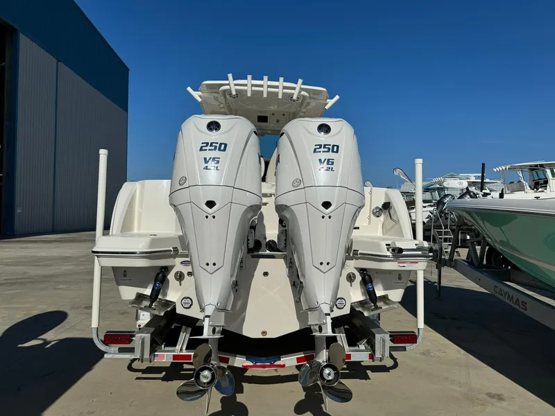 Slide: The Image of 2025 Sailfish 272 CC boat with twin 250 V6 engines, docked outdoors. - 5