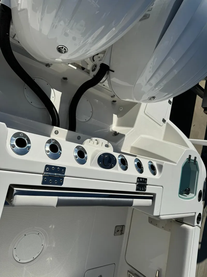 Slide: The Image of 2025 Sailfish 272 CC boat dashboard with controls and storage compartments. - 7