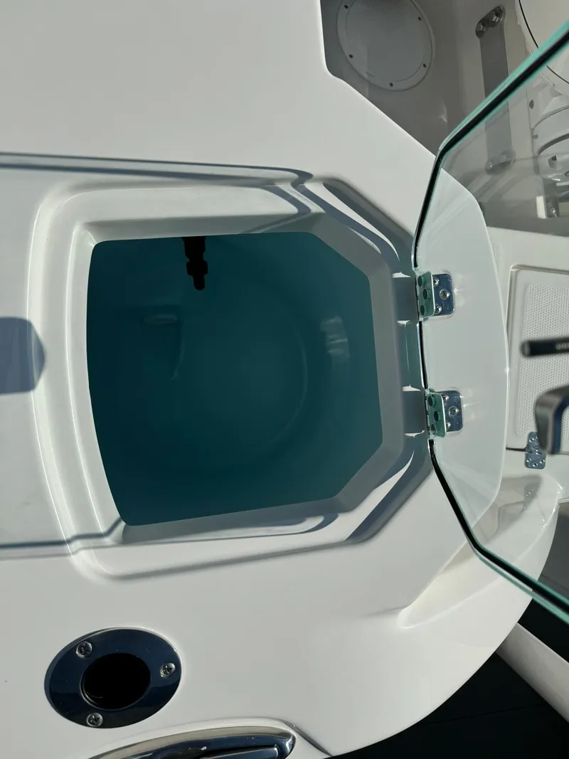 Slide: The Image of 2025 Sailfish 272 CC boat livewell with open lid and clear water. - 8