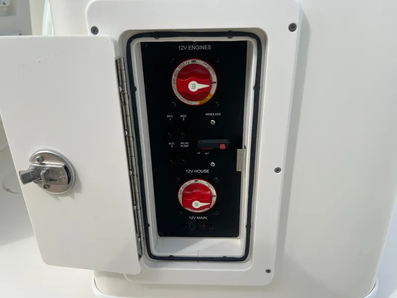 Slide: The Image of 2025 Cobia 240 Center Console electrical panel with open access door. - 14