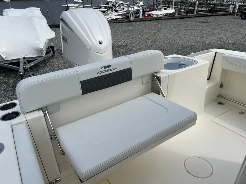 Slide: The Image of 2025 Cobia 240 Center Console boat with cushioned seating and Yamaha engine. - 18