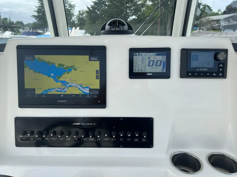 Slide: The Image of 2025 Cobia 240 Center Console dashboard with navigation and control panels. - 20
