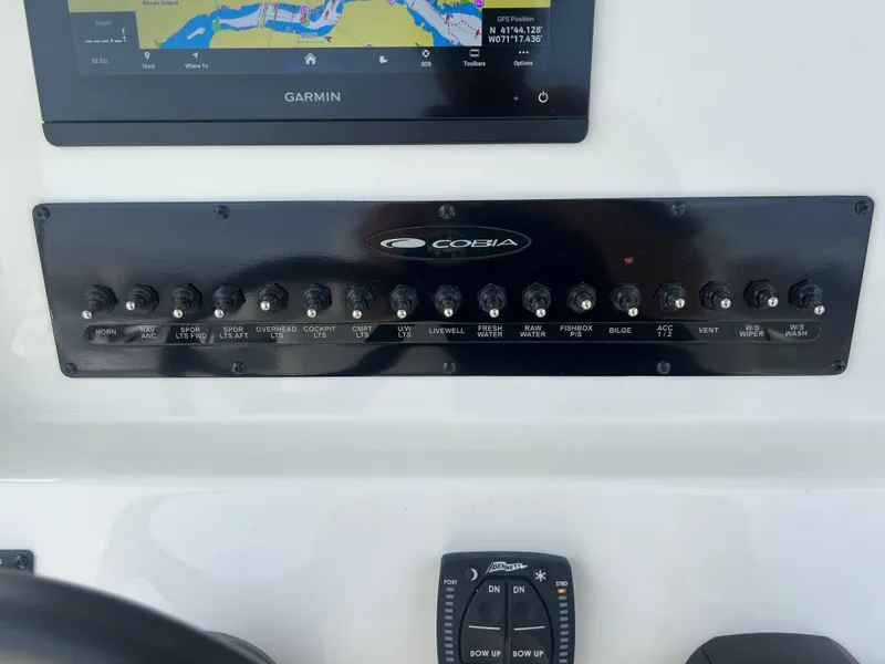 Slide: The Image of Control panel of 2025 Cobia 240 Center Console boat with Garmin navigation display. - 21