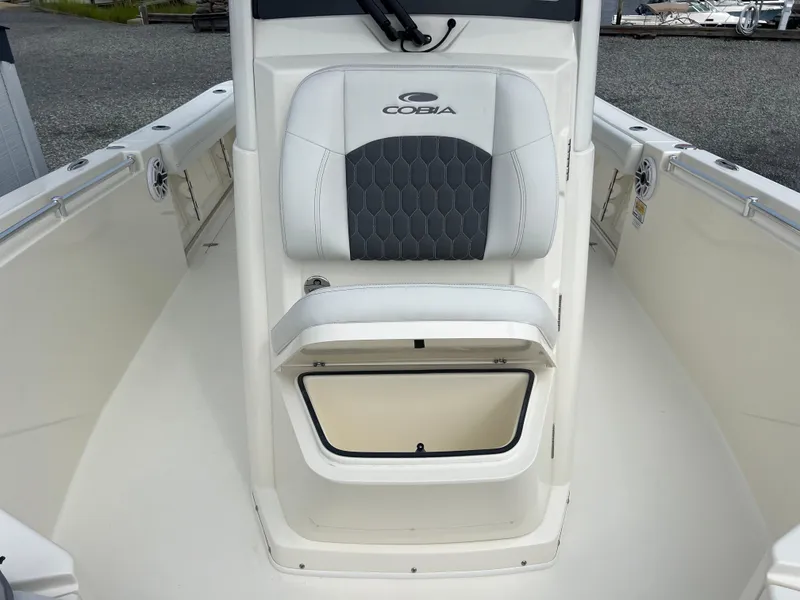 Slide: The Image of 2025 Cobia 240 Center Console boat interior with cushioned seating and storage compartment. - 27