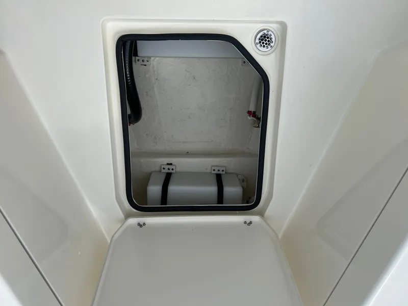 Slide: The Image of 2025 Cobia 240 Center Console storage compartment interior view. - 28