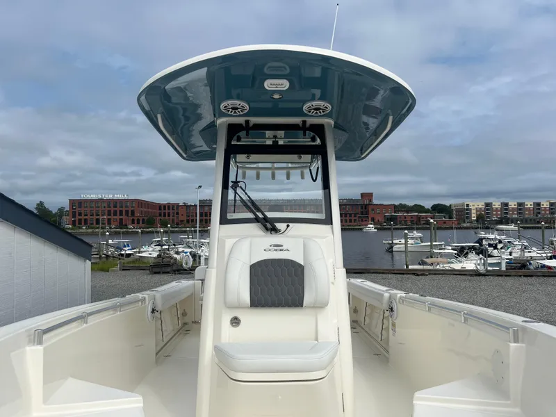 Slide: The Image of 2025 Cobia 240 Center Console boat docked at marina. - 29